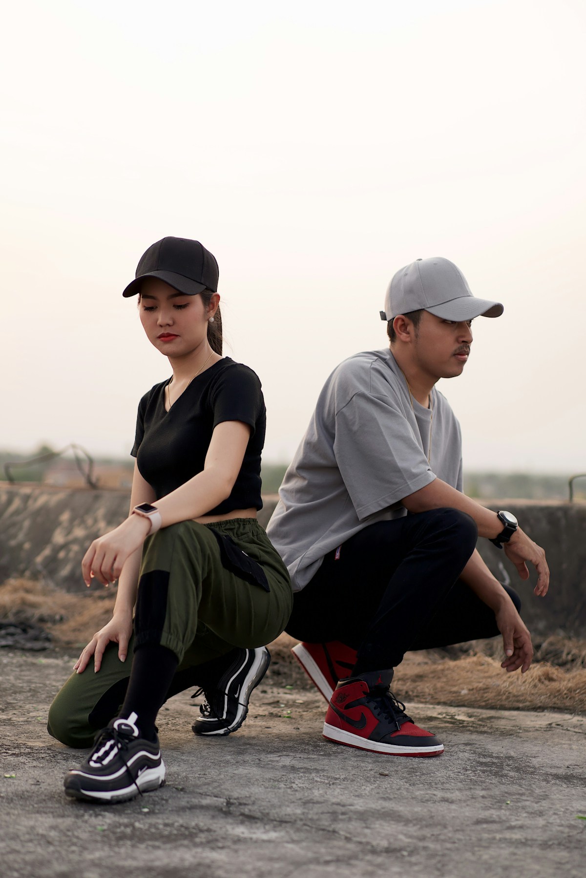 Two people styled in casual joggers and streetwear