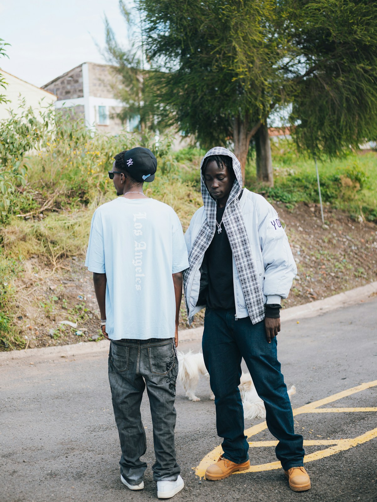 Two people wearing relaxed urban streetwear