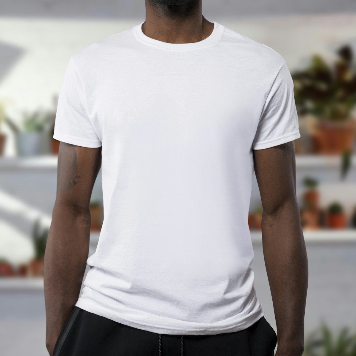 Model wearing a clean white basic T-shirt